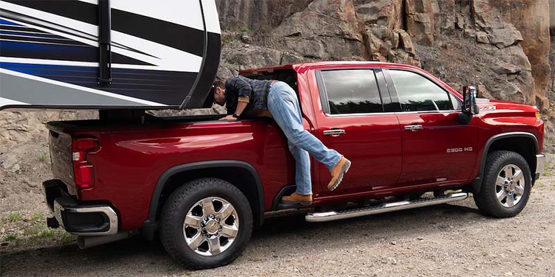 Photo of a person getting something from the trunk of a 2024 Silverado 3500 HD